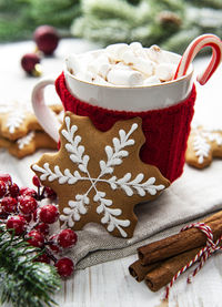 Christmas cocoa, gingerbread cookies and decorations. white wooden background.