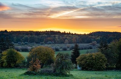 Scenic view of field against sky during sunset