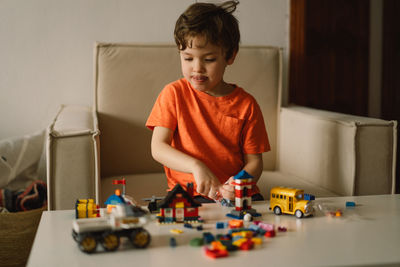Cute boy is playing constructor at home. kid playing block toys in home at nursery.