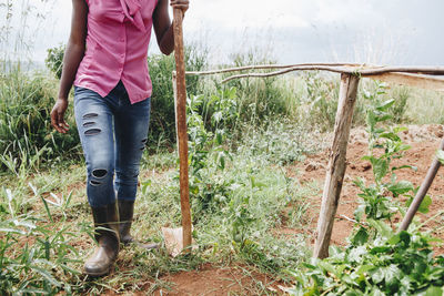 Low section of woman standing in grass