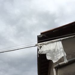 Low angle view of building against cloudy sky