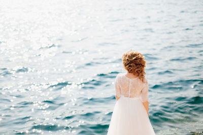 Rear view of bride looking at sea