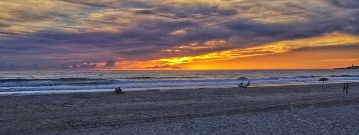 Scenic view of beach against sky during sunset