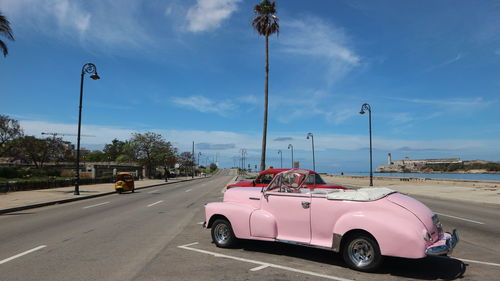 Cars on road against sky