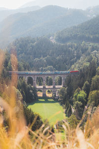 View of the kalte rinne railway viaduct and a passing train in semmering, rax-schneeberg, austria