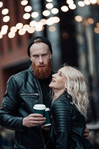 Portrait of young couple standing outdoors