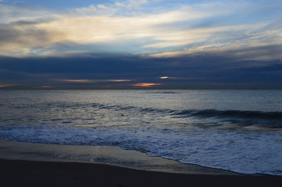 Scenic view of beach against sky during sunset