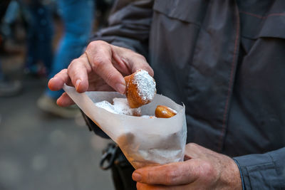 Midsection of man holding ice cream