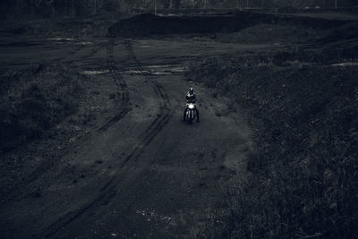 Man riding bicycle on road