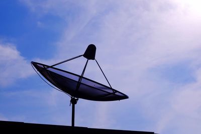 Low angle view of weather vane against sky