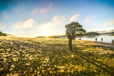 Man standing on field against sky