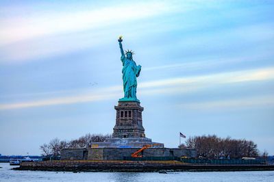 Low angle view of monument against cloudy sky