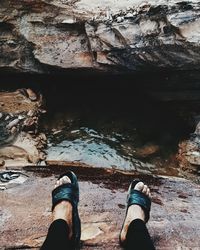 Low section of man standing on rock