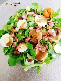 High angle view of chopped fruits in plate on table