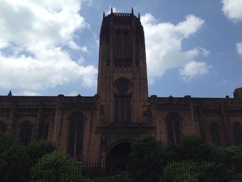 Low angle view of historical building against cloudy sky