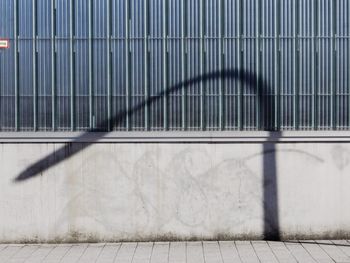Shadow of lamppost against wall