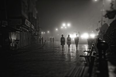 People strolling late night at a closed market street