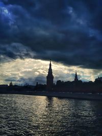 Silhouette of building against cloudy sky