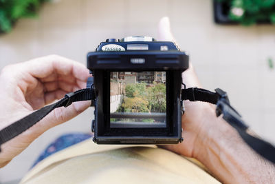 Close-up of person photographing camera on mobile phone