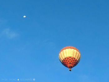 Low angle view of hot air balloon against blue sky