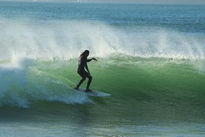 People surfing in sea