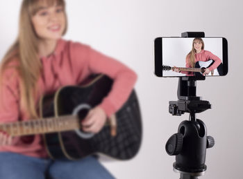 Midsection of woman holding guitar
