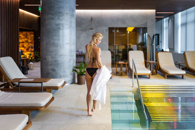 Full length of woman standing in corridor