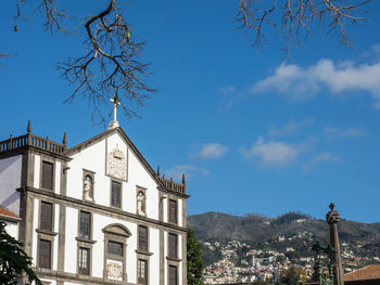 Low angle view of buildings against blue sky