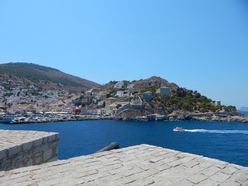 View of cityscape against clear blue sky