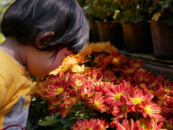 Close-up of girl smelling flowers