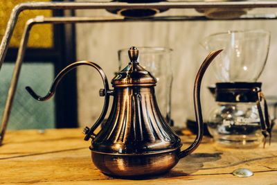 Close-up of antique kettle on table