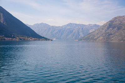 Scenic view of sea and mountains against sky