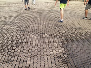Low section of people walking on footpath