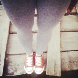 Low section of woman standing on tiled floor