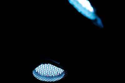 Close-up of illuminated lights over black background