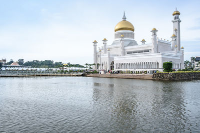 View of buildings at waterfront against sky