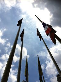 Low angle view of flags against sky