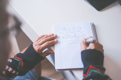 Cropped hand of man working on table