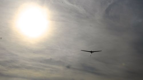 Low angle view of airplane flying in sky