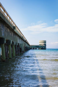 Scenic view of sea by building against sky