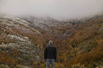 Portrait of adult man against autumn color trees on mountain, in tejera negra, guadalajara, spain