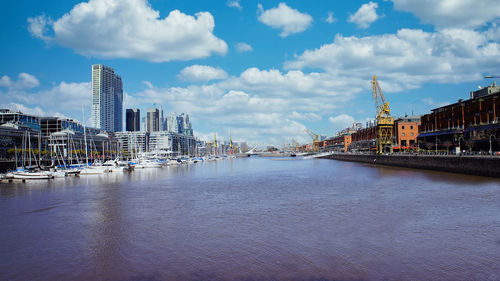 Bridge over river with buildings in background