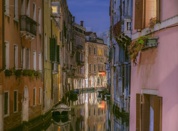 Panoramic view of canal amidst buildings against sky