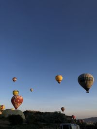 Low angle view of hot air balloons against blue sky