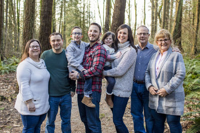 Close up portrait of happy family of eight in the forest.