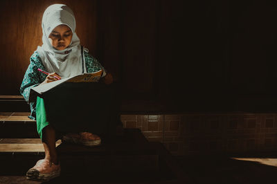 Girl studying in darkroom