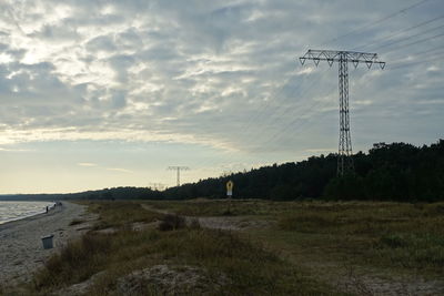 Electricity pylon on landscape against sky