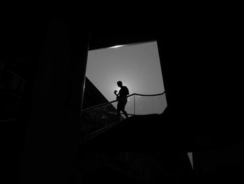 Silhouette man standing in corridor