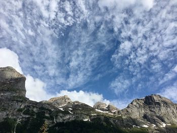 Low angle view of snowcapped mountains against sky