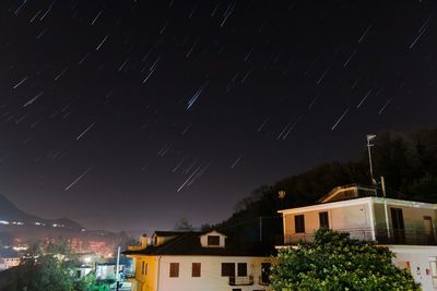 Illuminated city against sky at night